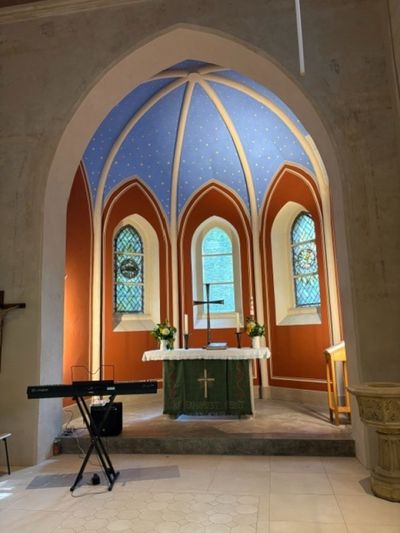 Kirchenraum mit blauem Sternengewölbe, Altar und Keyboard